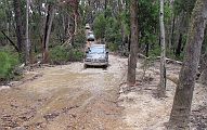 21-Iceman drives through a very muddy bog on the McGuire Track